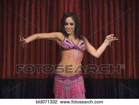 Middle Eastern woman belly dancing on stage View Large Photo Image Stock Image - Middle Eastern woman belly dancing on stage. Fotosearch