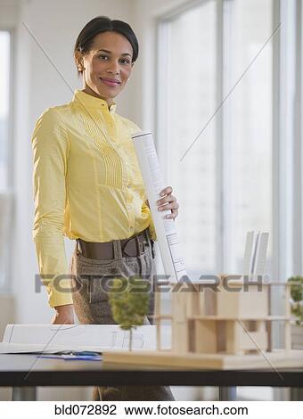 Mixed race architect with blueprints View Large Photo Image Stock Image - Mixed race architect with blueprints. Fotosearch