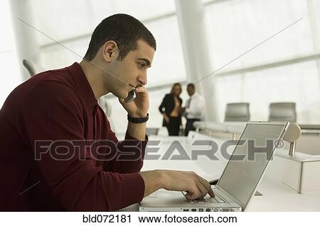 Mixed race businessman working on laptop View Large Photo Image Stock Image - Mixed race businessman working on laptop. Fotosearch