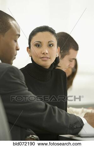 Stock Image - Mixed race businesswoman in meeting. Fotosearch