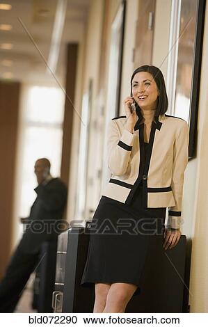 Mixed race businesswoman talking on cell phone View Large Photo Image Stock Image - Mixed race businesswoman talking on cell phone. Fotosearch
