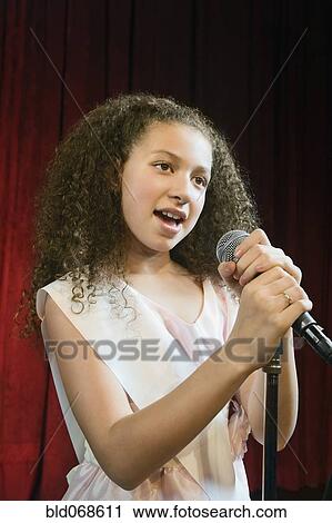 Stock Image - Mixed race girl competing in beauty pageant. Fotosearch