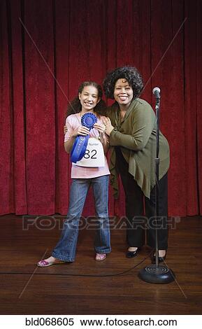 Mixed race girl receiving blue ribbon View Large Photo Image Stock Photography - Mixed race girl receiving blue ribbon. Fotosearch