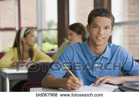 Stock Photo - Mixed race teenager doing homework. Fotosearch