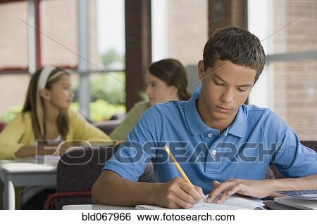Mixed race teenager doing homework View Large Photo Image Stock Photograph - Mixed race teenager doing homework. Fotosearch