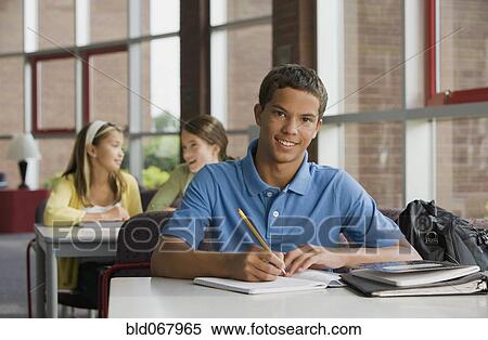 Stock Photography - Mixed race teenager doing homework. Fotosearch