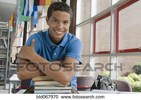 Mixed race teenager leaning on stack of books View Large Photo Image Stock Image - Mixed race teenager leaning on stack of books. Fotosearch