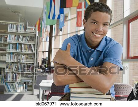 Mixed race teenager leaning on stack of books View Large Photo Image Stock Image - Mixed race teenager leaning on stack of books. Fotosearch