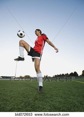 Mixed race woman bouncing soccer ball on knee View Large Photo Image Stock Image - Mixed race woman bouncing soccer ball on knee. Fotosearch