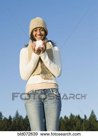 Mixed race woman drinking coffee outdoors View Large Photo Image Stock Photo - Mixed race woman drinking coffee outdoors. Fotosearch