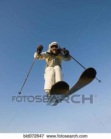 Mixed race woman on skis in mid-air View Large Photo Image Stock Photo - Mixed race woman on skis in mid-air. Fotosearch