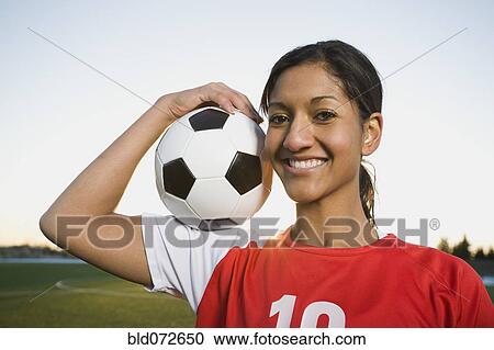Mixed race woman posing with soccer ball View Large Photo Image Stock Image - Mixed race woman posing with soccer ball. Fotosearch