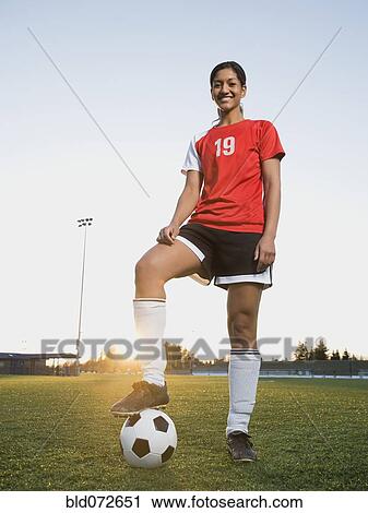 Mixed race woman posing with soccer ball View Large Photo Image Stock Image - Mixed race woman posing with soccer ball. Fotosearch