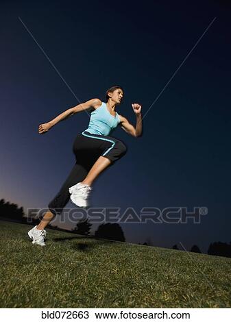 Mixed race woman running on grass View Large Photo Image Stock Image - Mixed race woman running on grass. Fotosearch