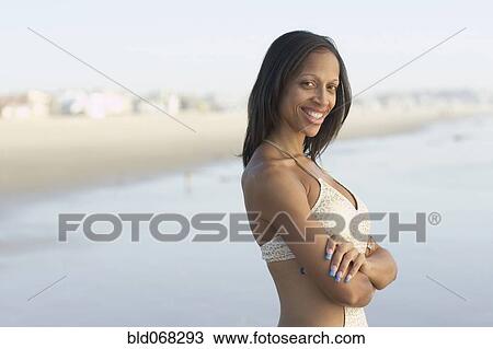 Mixed race woman with arms crossed at beach View Large Photo Image Stock Image - Mixed race woman with arms crossed at beach. Fotosearch
