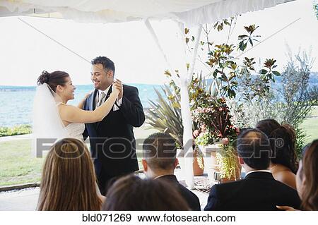 Stock Photo - Multi-ethnic bride and groom dancing. Fotosearch