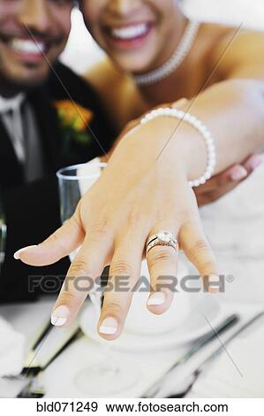Multi-ethnic bride and groom showing ring View Large Photo Image Stock Photo - Multi-ethnic bride and groom showing ring. Fotosearch