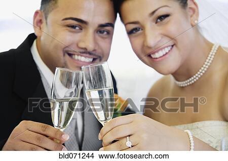 Picture - Multi-ethnic bride and groom toasting. Fotosearch