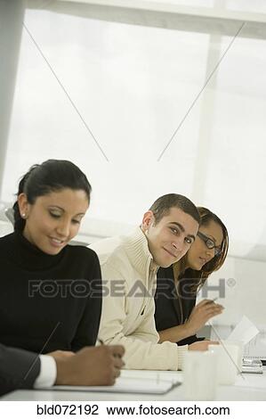 Stock Image - Multi-ethnic business people in meeting. Fotosearch