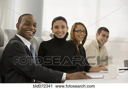 Stock Image - Multi-ethnic business people posing in meeting. Fotosearch