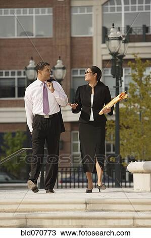 Multi-ethnic businesspeople talking outdoors View Large Photo Image Stock Image - Multi-ethnic businesspeople talking outdoors. Fotosearch