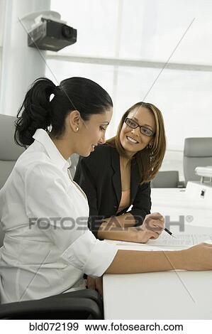 Stock Photo - Multi-ethnic businesswomen in meeting. Fotosearch