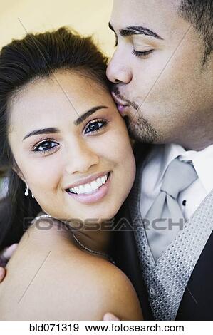 Stock Photo - Multi-ethnic couple hugging. Fotosearch