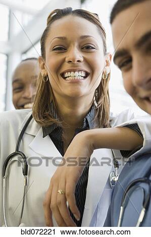 Stock Image - Multi-ethnic doctor and nurses posing. Fotosearch