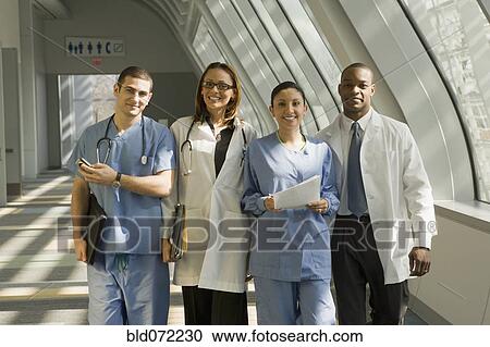 Stock Image - Multi-ethnic doctors and nurses posing in corridor. Fotosearch
