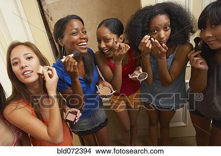 Multi-ethnic group of friends applying makeup View Large Photo Image Picture - Multi-ethnic group of friends applying makeup. Fotosearch