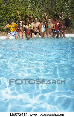 Picture - Multi-ethnic group of friends enjoying pool party. Fotosearch