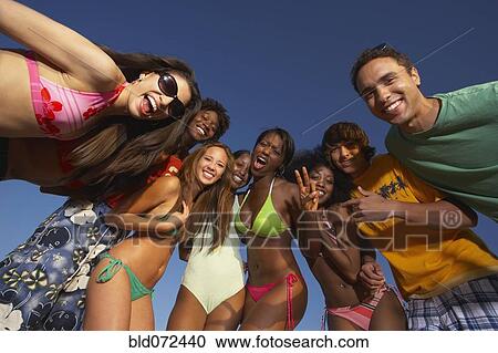 Multi-ethnic group of friends hugging View Large Photo Image Stock Image - Multi-ethnic group of friends hugging. Fotosearch