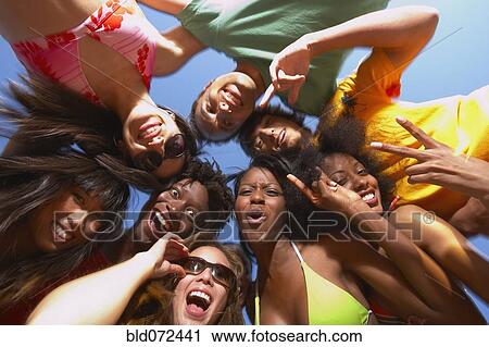 Stock Image - Multi-ethnic group of friends hugging. Fotosearch