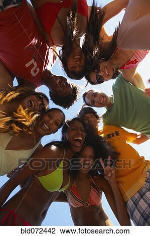 Multi-ethnic group of friends hugging View Large Photo Image Stock Image - Multi-ethnic group of friends hugging. Fotosearch