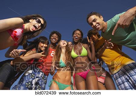 Multi-ethnic group of friends hugging View Large Photo Image Stock Photo - Multi-ethnic group of friends hugging. Fotosearch