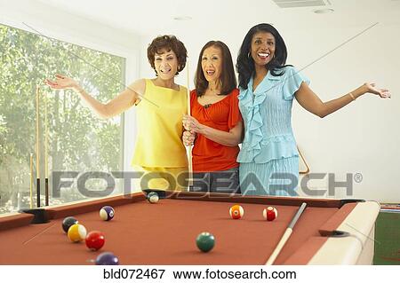 Multi-ethnic group of friends playing pool View Large Photo Image Stock Photo - Multi-ethnic group of friends playing pool. Fotosearch