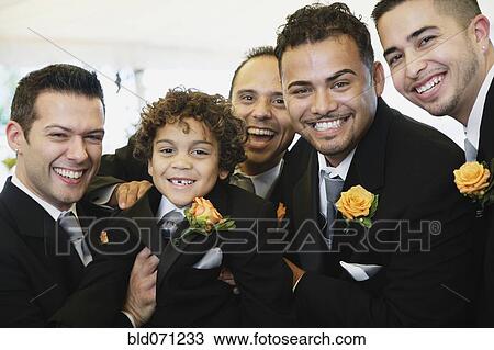 Stock Image - Multi-ethnic men and boy wearing tuxedos. Fotosearch