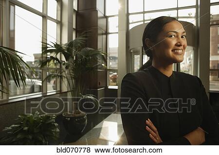 Stock Photo - Portrait of Asian businesswoman with arms crossed. Fotosearch