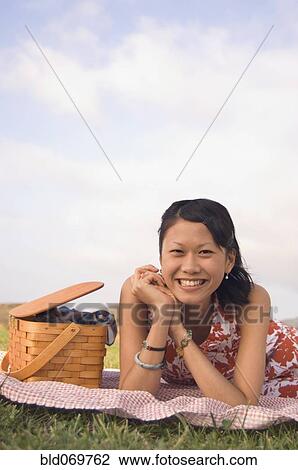 Portrait of Asian woman next to picnic basket View Large Photo Image Stock Image - Portrait of Asian woman next to picnic basket. Fotosearch