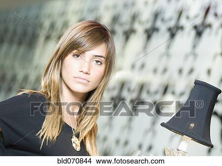 Picture - Portrait of Hispanic woman next to lamp. Fotosearch