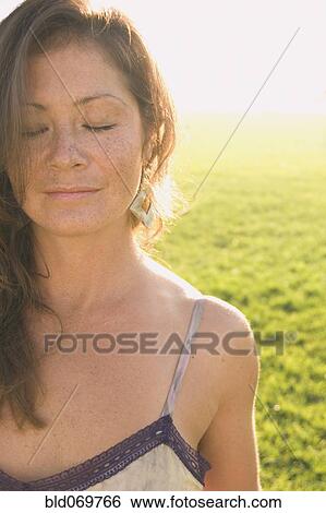 Portrait of woman in sunlit meadow View Large Photo Image Stock Photograph - Portrait of woman in sunlit meadow. Fotosearch