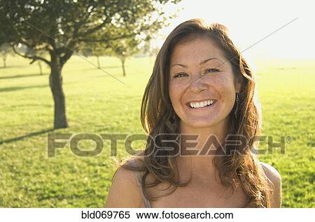 Portrait of woman in sunlit meadow View Large Photo Image Stock Photography - Portrait of woman in sunlit meadow. Fotosearch