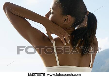 Rear view of African woman stretching outdoors View Large Photo Image Stock Photography - Rear view of African woman stretching outdoors. Fotosearch