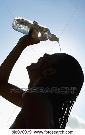 Silhouette of woman pouring water over head View Large Photo Image Stock Photo - Silhouette of woman pouring water over head. Fotosearch
