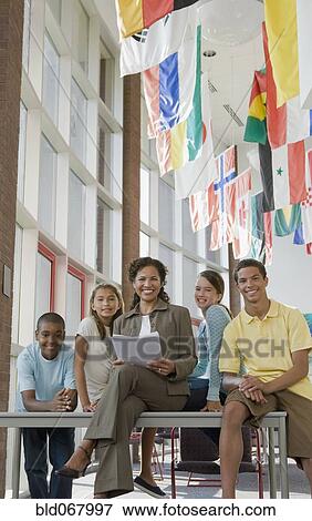 Stock Photo - Teacher and students posing in classroom. Fotosearch