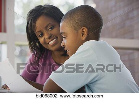 Teacher helping student with homework View Large Photo Image Stock Image - Teacher helping student with homework. Fotosearch