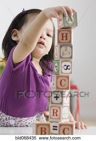 Toddler girl playing with blocks View Large Photo Image Stock Photography - Toddler girl playing with blocks. Fotosearch