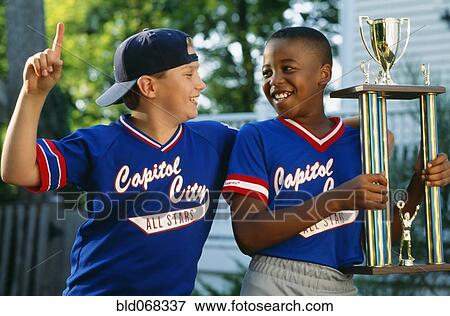 Stock Photo - Two boys with baseball trophy. Fotosearch