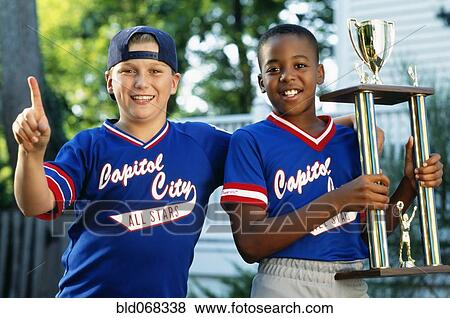 Stock Photo - Two boys with baseball trophy. Fotosearch