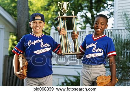 Stock Photo - Two boys with baseball trophy. Fotosearch